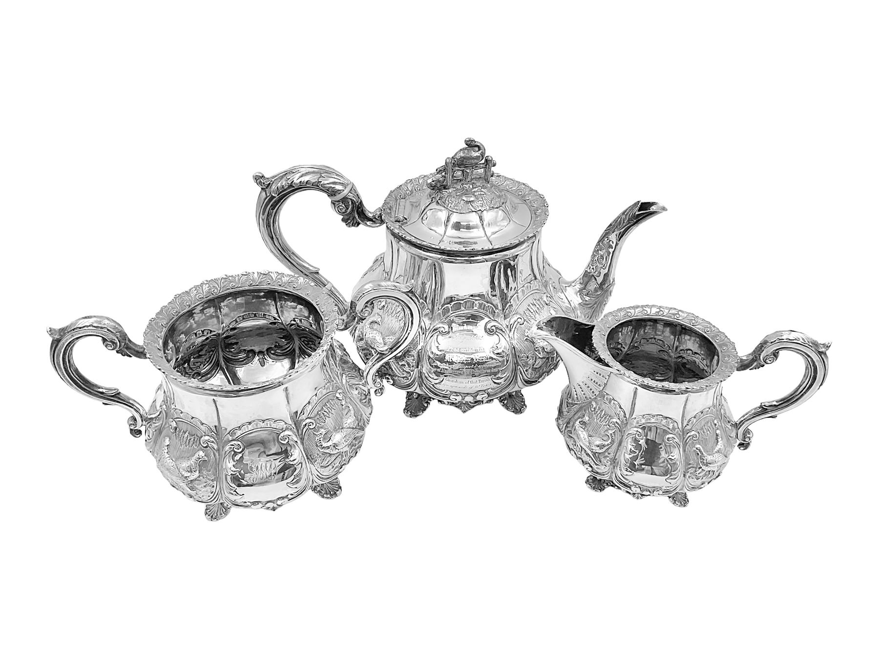 Victorian silver three piece tea service, comprising teapot, twin handled open sucrier, and milk jug, each of bellied form with acanthus capped scroll handles, the sides embossed with alternating scroll edged vacant panels and panels containing a pair of birds, upon four palmette feet, the teapot with ivory insulators to handle, and bird finial to the hinged domed cover, hallmarked William Hunter & Son, London 1861, teapot H19cm, including handles sucrier H13.5cm, including handle milk jug H12cm

This item has been registered for sale under Section 10 of the APHA Ivory Act