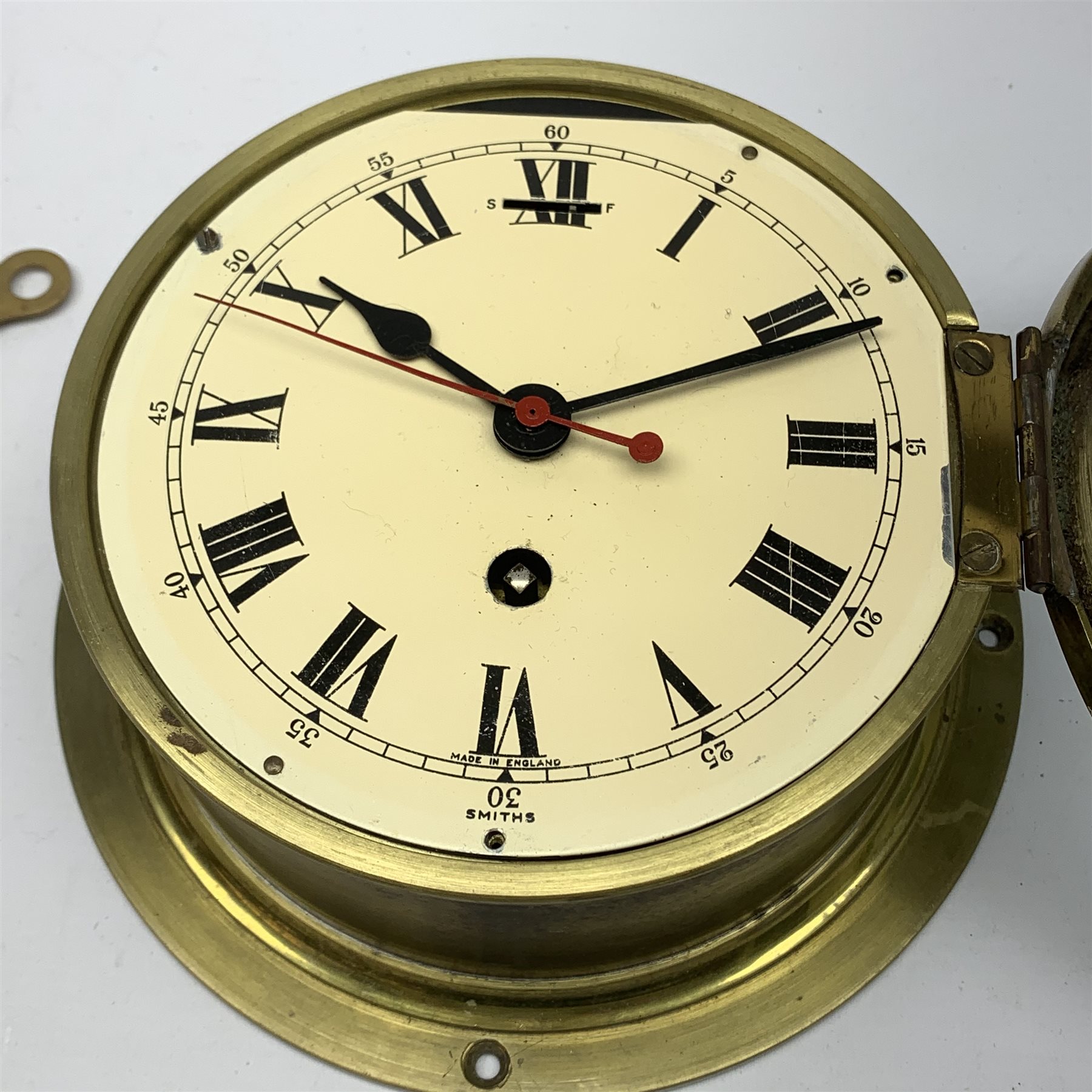 Smiths ship's brass cased bulkhead clock, the cream dial with Roman