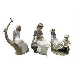 Three Nao figures, comprising 'Lazy Afternoon' no. 1523, 'Bandaging the Foot' no. 448 and 'Spring Reflections' no. 1392, tallest H32cm
