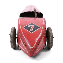 Mettoy tinplate clockwork racing car, the boat tailed red body with lithographed details, racing no. 7, with Dunlop Fort tyres, driver and key, H8cm, L32cm