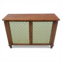 Late 20th century Regency style mahogany side cabinet, the rectangular crossbanded top with ebonised line inlay, above a pair of brass lattice grille doors with pale green fabric backing enclosing a shelved interior and two frieze drawers, flanked by reeded corner pilasters, upon turned tapering feet