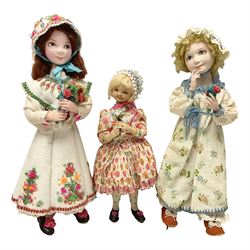 Anna Meszaros Hungary - three hand made needlewrok figurines - each wearing a lon floral dress and bonnet and holding a bouquet of flowers, tallest H32cm (3)  Auctioneer's Note: Anna Meszaros came to England from her native Hungary in 1959 to marry an English businessman she met while demonstrating her art at the 1958 Brussels Exhibition. Shortly before she left for England she was awarded the title of Folk Artist Master by the Hungarian Government. Anna was a gifted painter of mainly portraits and sculptress before starting to make her figurines which are completely hand made and unique, each with a character and expression of its own. The hands, feet and face are sculptured by layering the material and pulling the features into place with needle and thread. She died in Hull in 1998.