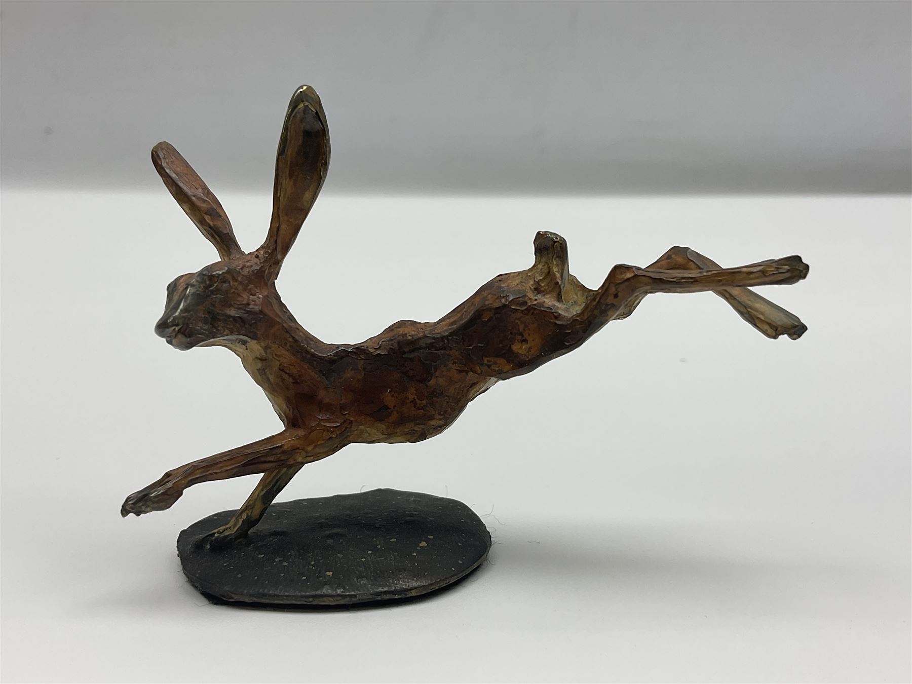Michael Storey (British 1948-): 'Running Hare', bronze of a hare, H7cm, L10cm 