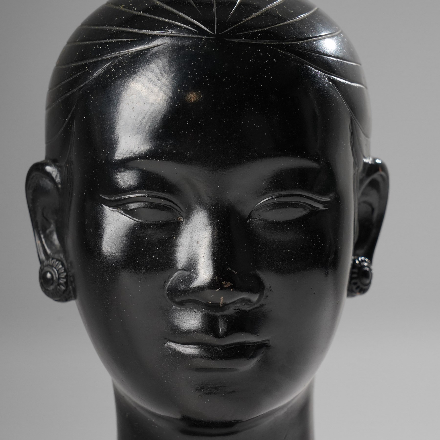 Manner of Nguyen Thanh Le (Vietnamese 1919-2006): Head of a Woman, bronze bust with indistinct character signature to neck, on ebonised base, H27cm 