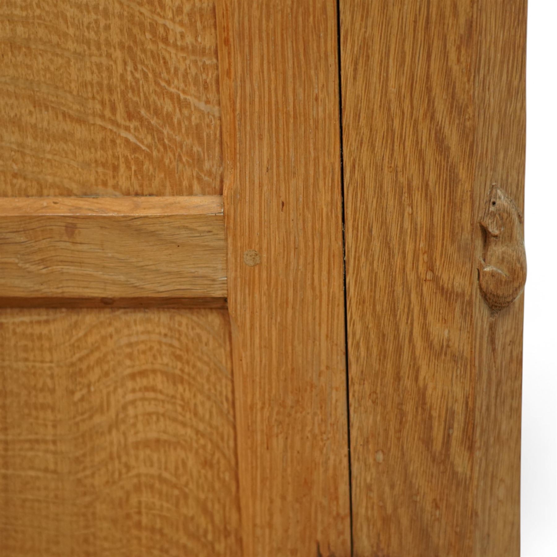 Mouseman - oak sideboard rectangular adzed top with raised back over three central drawers and two flanking cupboards, enclosed by panelled doors with wrought metal fixtures, the canted upright carved with mouse signature, on octagonal feet, by the workshop of Robert Thompson, Kilburn