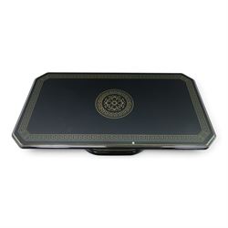 Italian Neoclassical inspired ebonised gloss coffee table, glazed cantered top with Greek key banding, on a shaped pedestal base with gilt highlights and stepped plinth 