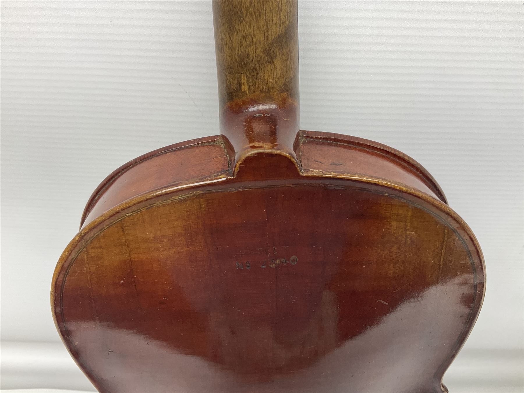 Late 19th century French three-quarter size 'Conservatory' violin with 34cm two-piece maple back and ribs and spruce top, the peg box inscribed 'Conservatory Violin Straduari', bears label 'Antonius Stradiuarius Cremonensis Faciebat Anno 1721' L55.5cm overall; in ebonised wooden 'coffin' case; and Saxony violin c1900 with 36cm two-piece maple back and ribs and spruce top; bears label 'Antonius Stradivarius Cremonensis Faciebat Anno 17**' L59cm overall; in carrying case (2)