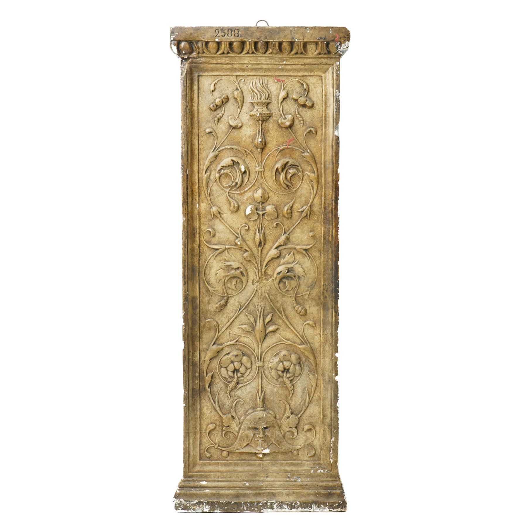 D Brucciani, London - After the antique -  A relief moulded plaster panel No2538 with stylised trailing leaves, flower heads and a mask 62cm x 22cm