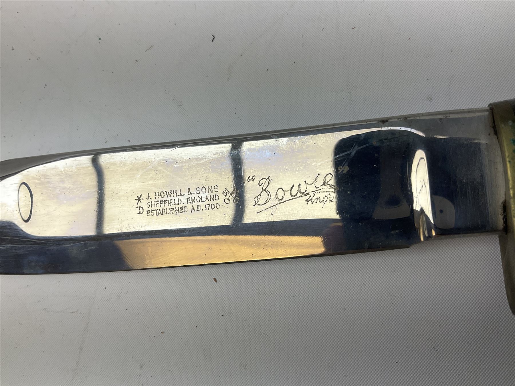 Bowie knife by J. Nowill & Sons Sheffield England Est. AD1700,  with 17.5cm steel blade, brass cross-piece, antler grip and alloy pommel; in leather sheath L32cm overall