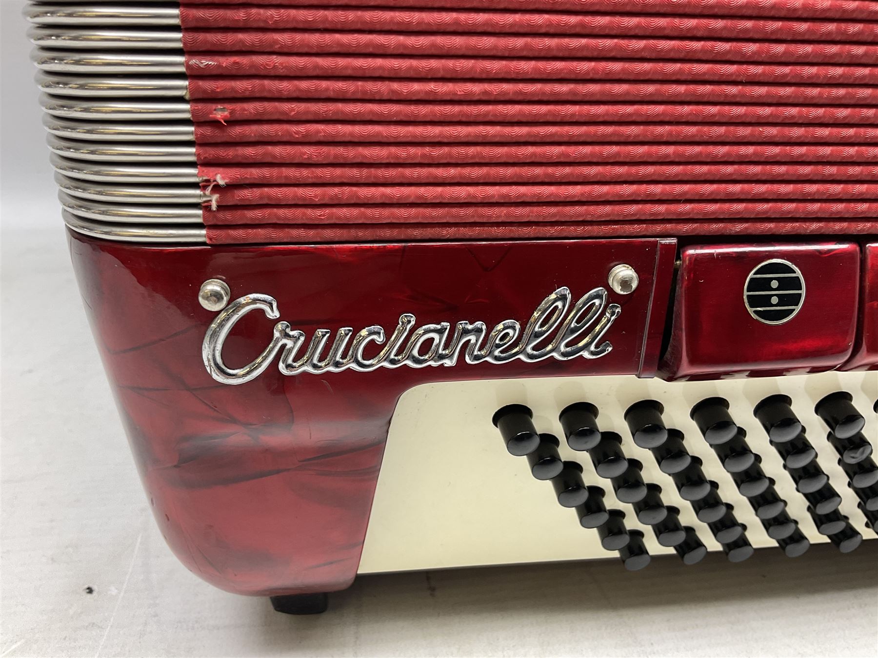Clinkscale Crucianelli piano accordion in red pearline case with one-hundred and twenty buttons and forty-one keys L52cm; in carrying case