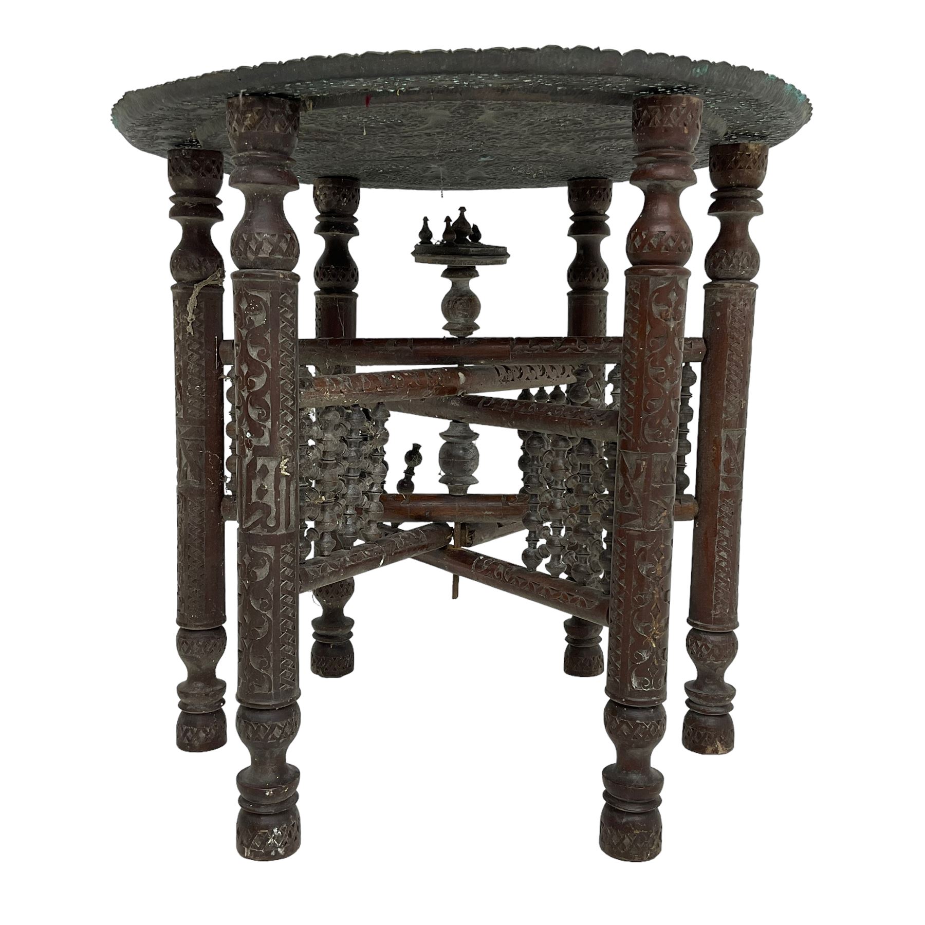 Anglo-Indian Benares table, circular pierced copper top decorated with trailing foliage, on folding hardwood stand carved with scrolls and incised decoration