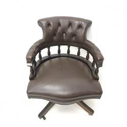 20th century swivel captains chair, upholstered in deep buttoned and studded chocolate leather, four supports, W63cm