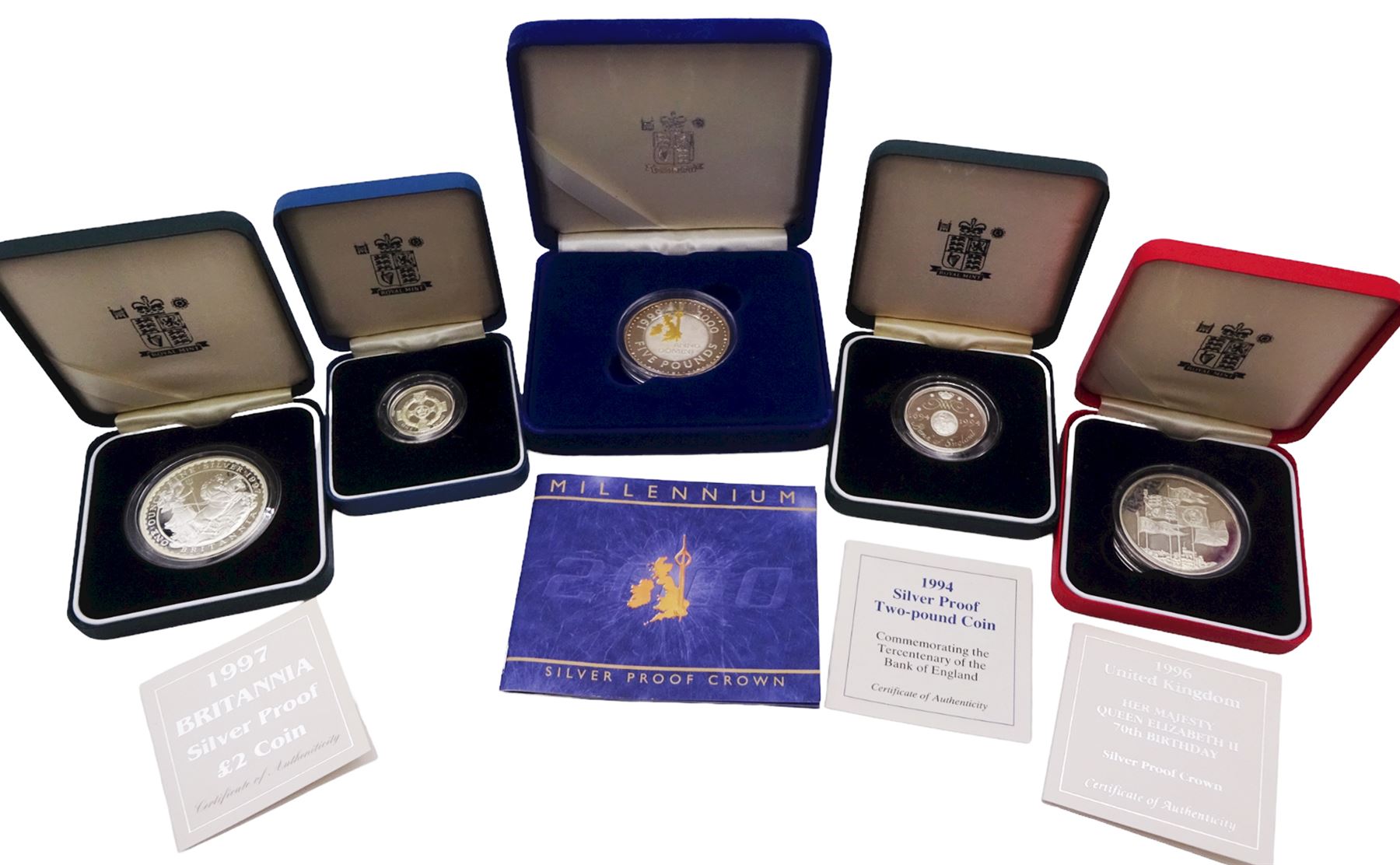 Five The Royal Mint United Kingdom silver proof coins, comprising 1994 two pound commemorating the Tercentenary of the Bank of England, 1996 five pounds commemorating Her Majesty the Queen Elizabeth II 70th birthday, 1997 two pound Britannia, 2000 'Millennium' five pound, all cased with certificate, and 1996 one pound, cased without certificate