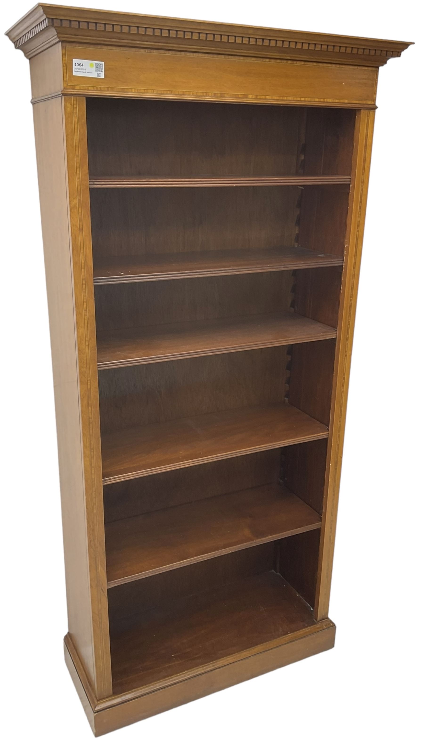 Edwardian inlaid mahogany open bookcase, projecting dentil cornice over crossbanded frieze, fitted with four adjustable shelves with reeded facias, on skirted base