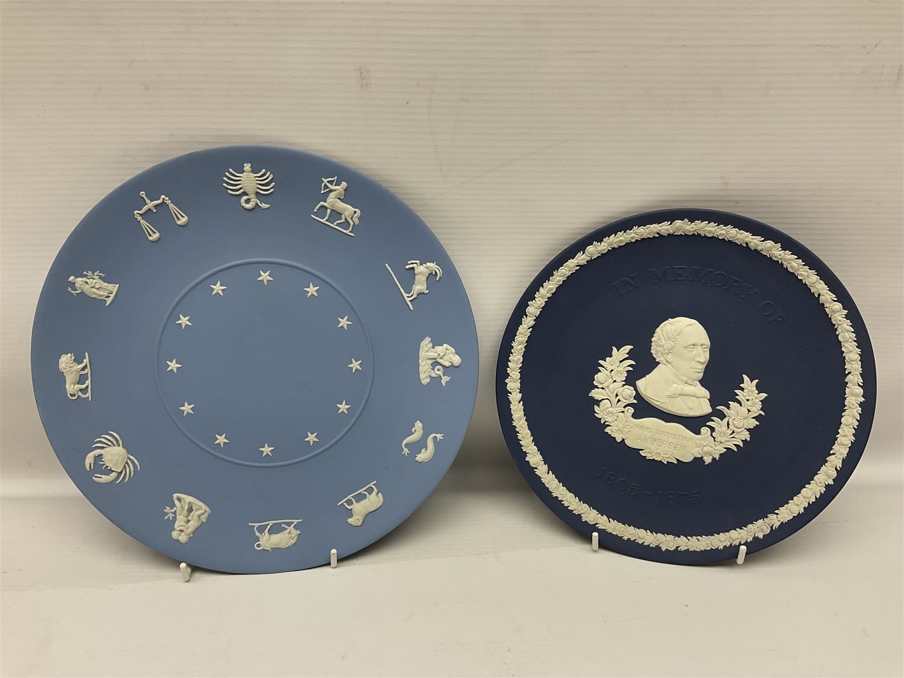 Collection of Wedgwood Jasperware, to include black Eisenhower Bust, two black basalt paperweights, one depicting an eagle and one depicting Julius Caesar, a blue Zodiac plate, Man on the Moon commemorative plate, American Independence Bicentennial plate and Royal commemorative ware, etc, all with impressed marks beneath, some with boxes