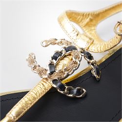 Chanel - pair of gold leather thong sandals, from the 2021 Summer Collection, the uppers centred with an interlocking gold tone CC motif in chain and leather, size 37C, unused with original dust bags