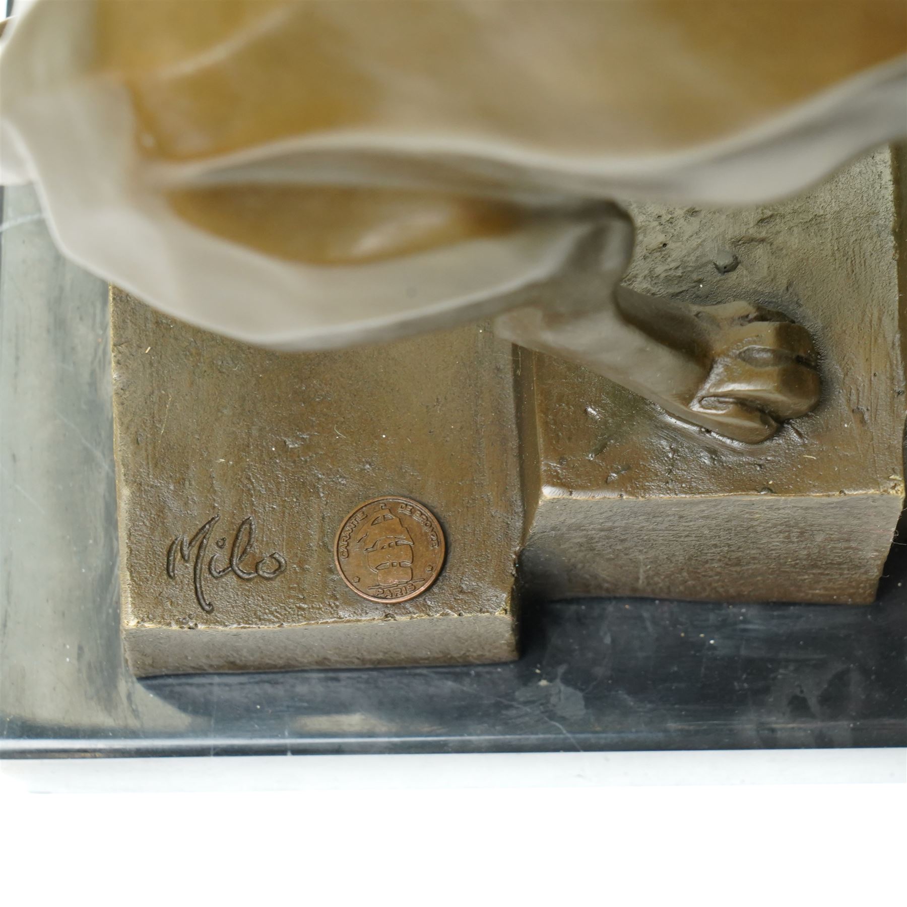 After Milo - bronze model of an art deco style lion climbing steps, bearing signature and foundry mark, overall H32cm 