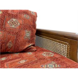 Ercol medium elm framed three seat bergere sofa, and pair of matching armchairs upholstered in red fabric