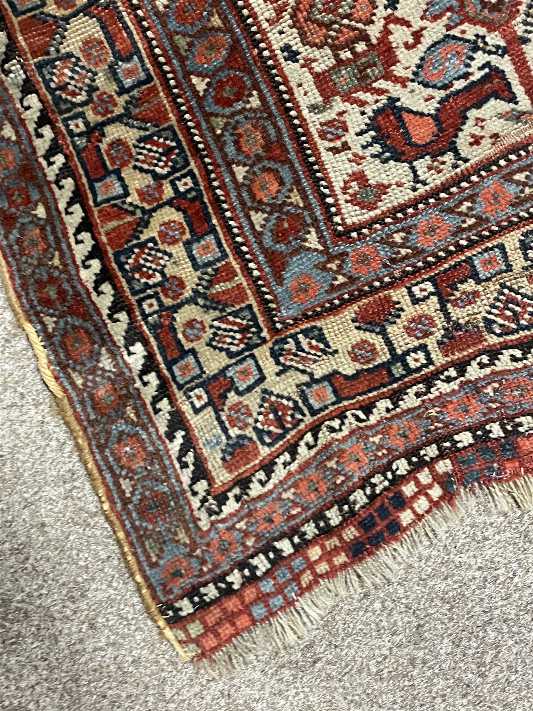 Persian rug, blue ground field decorated with quadruple pole medallion surrounded by animal motifs and stylised flower heads, multiple band border