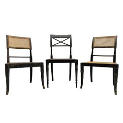 Collection of Regency dining chairs - set of four Regency painted beech dining chairs, with cane seat and back, on collar turned supports with splayed feet (W46cm, H84cm); a pair of Regency ebonised dining chairs (W47cm, H77cm); and a single Regency dining chair, the cresting rail painted with floral cornucopias and central putto vignette, X-frame back over cane seat, on collar turned front supports painted with foliage (W46cm, H84cm) (7)