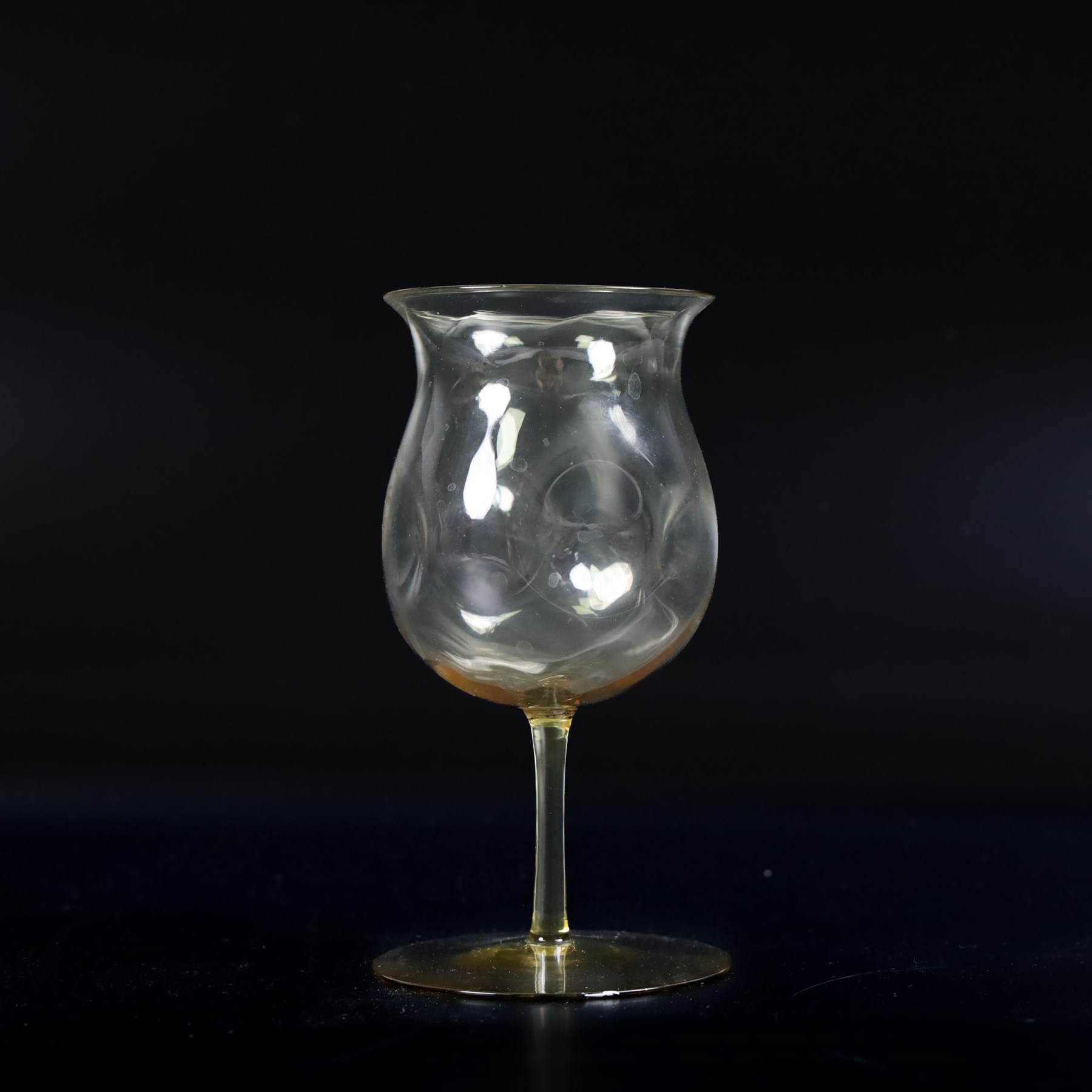 Four Arts and Crafts drinking glasses of dimple form, probably James Powell, Whitefriars, together with a dimple decanter, glasses H12cm