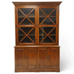 OKA - Glazed bookcase dark oark cabinet, the top with projecting cornice above astragal style glazed doors metal turned knobs, enclosing adjustable full length shelving, the lower half with two sets of twin cabinet doors housing fixed shelving, raised on a moulded plinth base  
