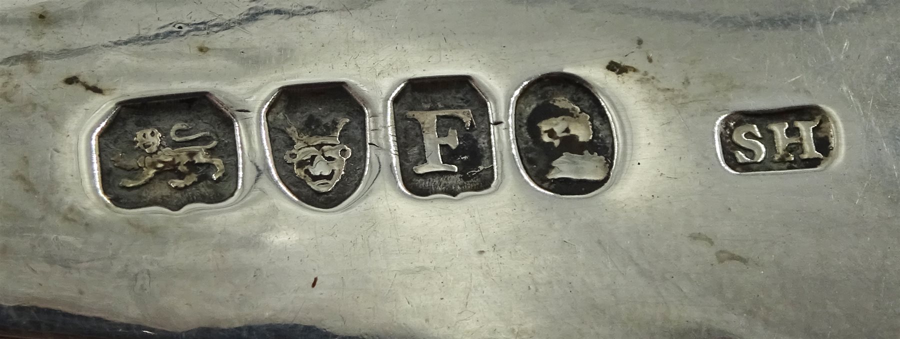 George III silver berry spoon by Solomon Hougham, London 1801 and a George III silver fork, fiddle pattern with bright cut floral decoration by Thomas Wilkes Barker, London 1805, approx 4.5oz