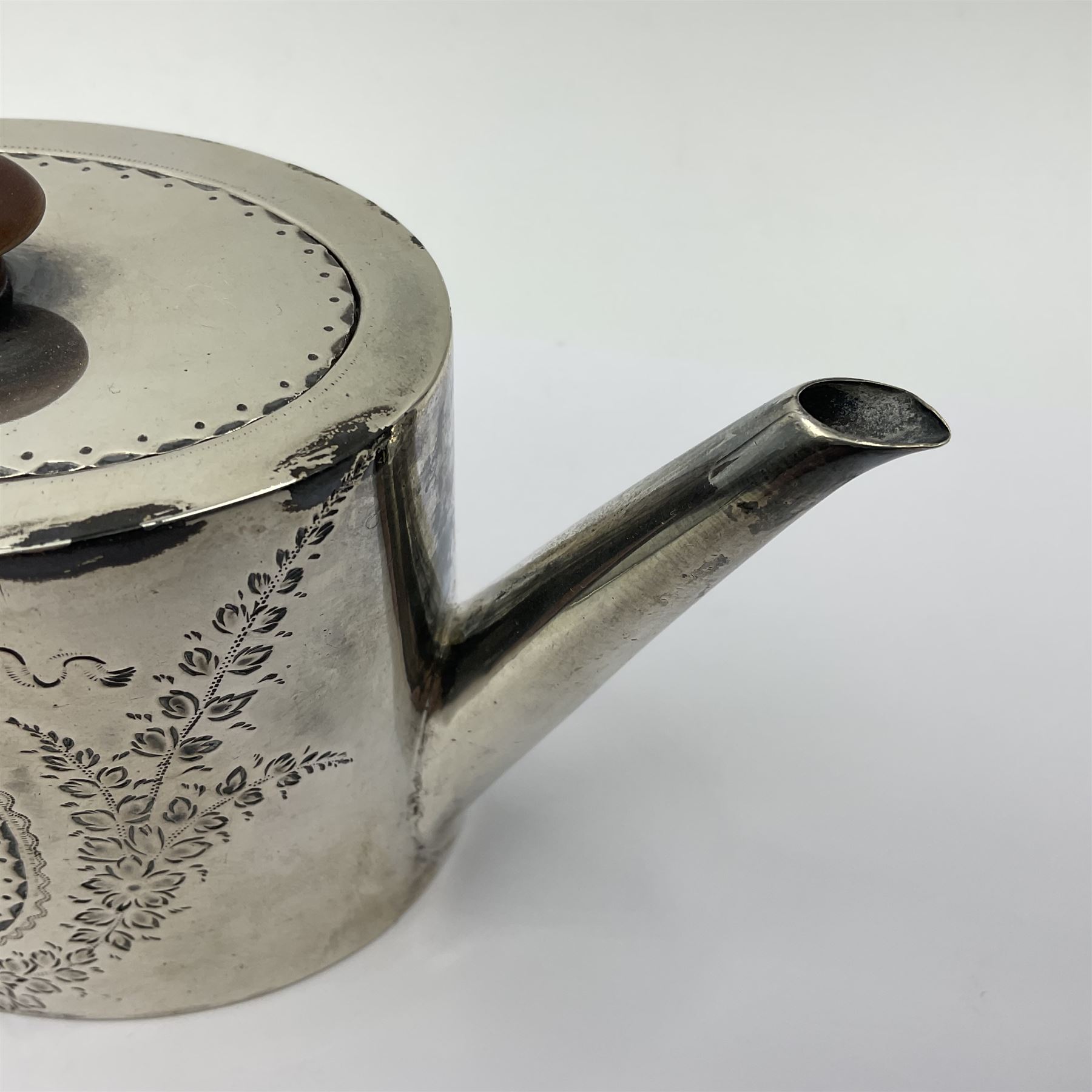 George III silver bachelors teapot, of oval form with wooden scroll handle and finial, the body chased with armorial crest and ribbon swag and foliate detail, hallmarked Samuel Godbehere & Edward Wigan, London 1793, including handle H9cm