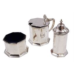 1920s silver three piece cruet set, comprising mustard pot and cover, pepper and open salt, each of faceted octagonal form, the mustard pot with pierced thumbpiece and capped handle, hallmarked Stokes & Ireland Ltd, Chester 1923 & 1924, max height 8.5cm, mustard and salt with original blue glass liners