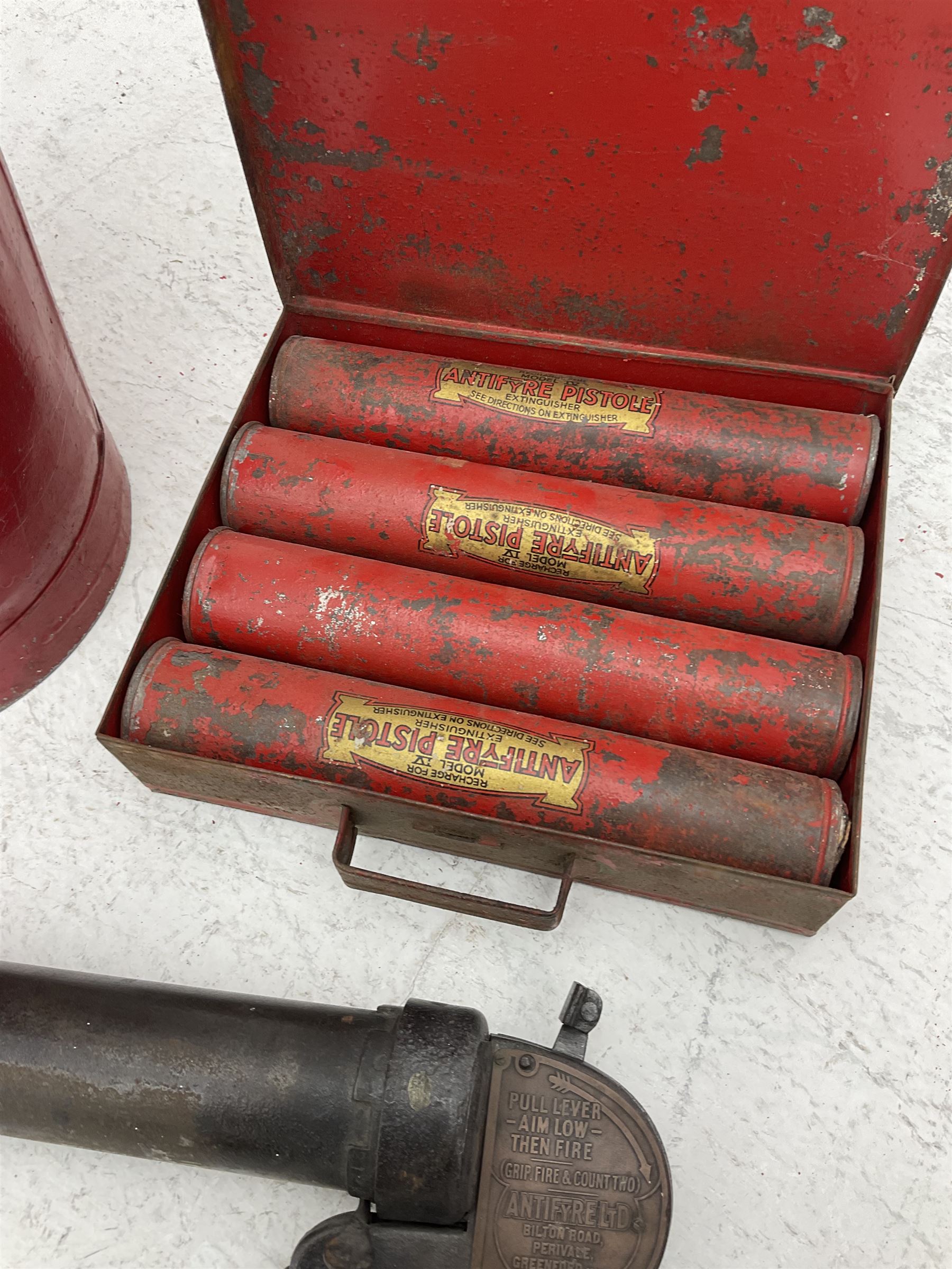 Antifyre Pistole fire extinguisher grenade launcher together with four cartridges (one lacking contents) in original storage tin, together with a red painted fire bucket