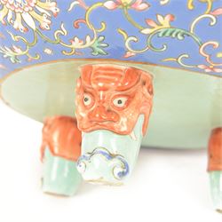 20th century Chinese footed bowl, of circular form, decorated in polychrome enamels with flowers and foliage on a cobalt blue ground, upon three grotesque mounted feet, with character marks beneath, H13cm, D38cm