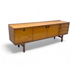White & Newton - mid-20th century teak sideboard, rectangular top with raised back over fall-front storage compartment, double cupboard and three drawers, raised on cylindrical supports