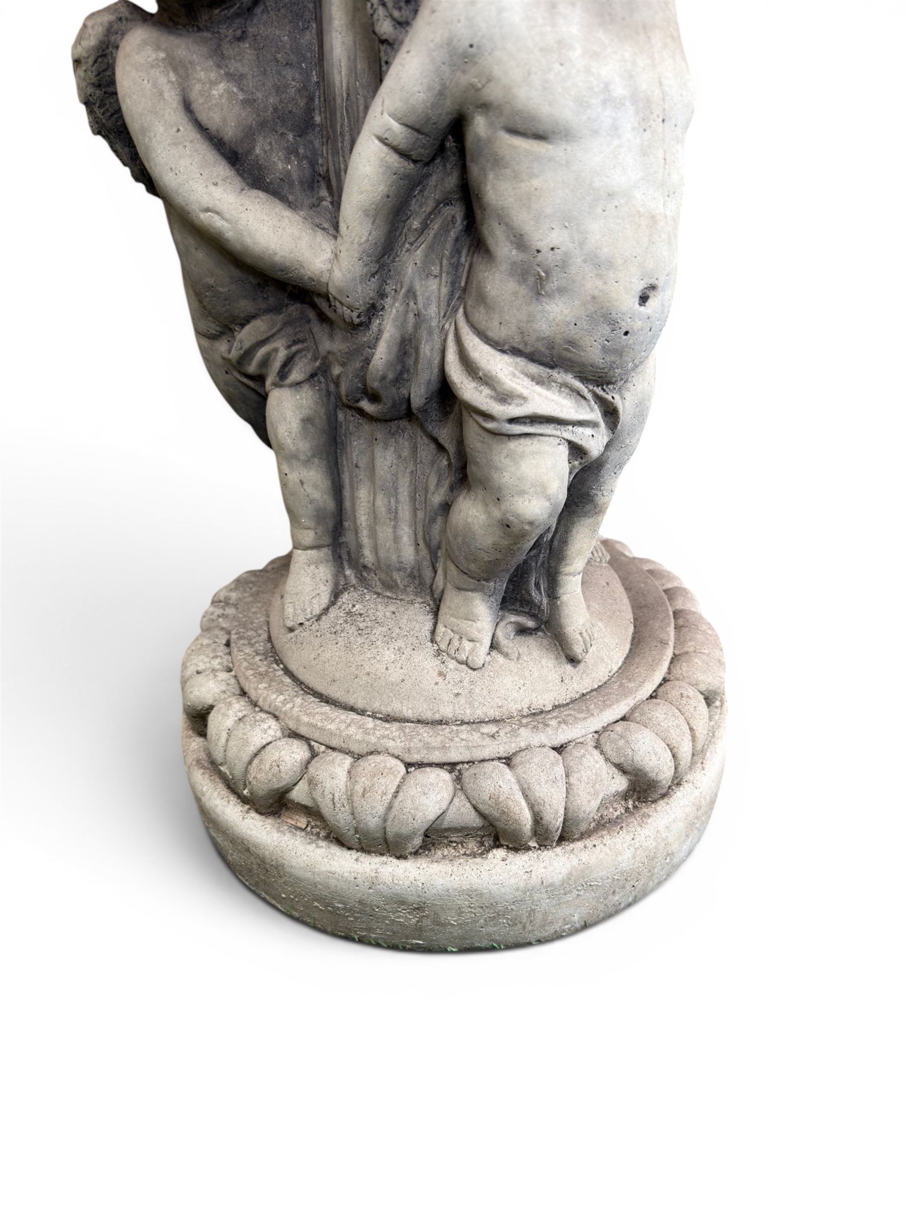 Cast stone cherub bird bath, circular removable top raised on three cherubs with ornate detailing
