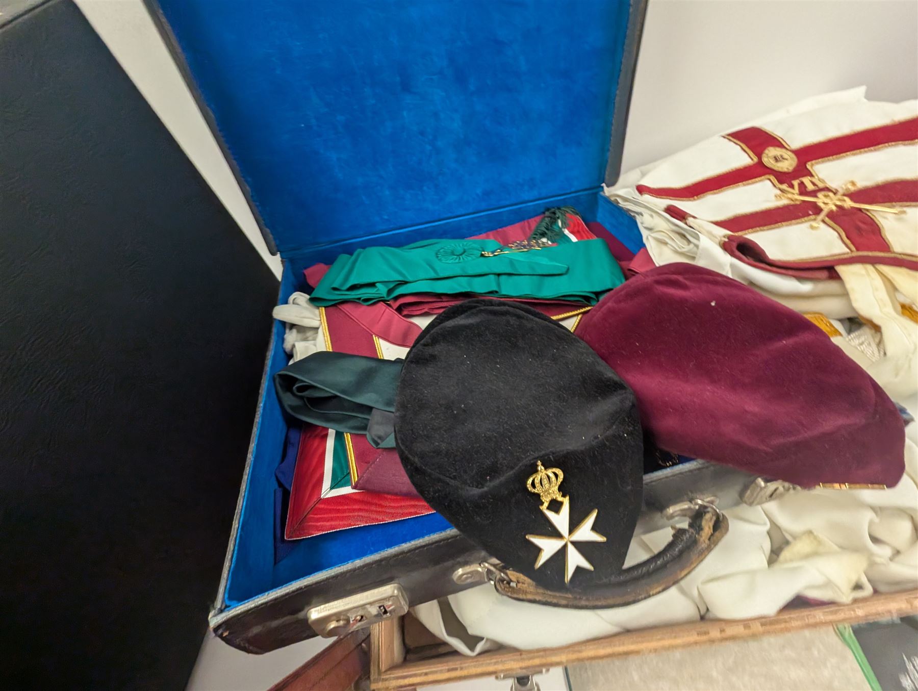 Collection of Masonic jewels and regalia, including robes, sashes, gloves, medallions, etc, in a number of briefcases and boxes