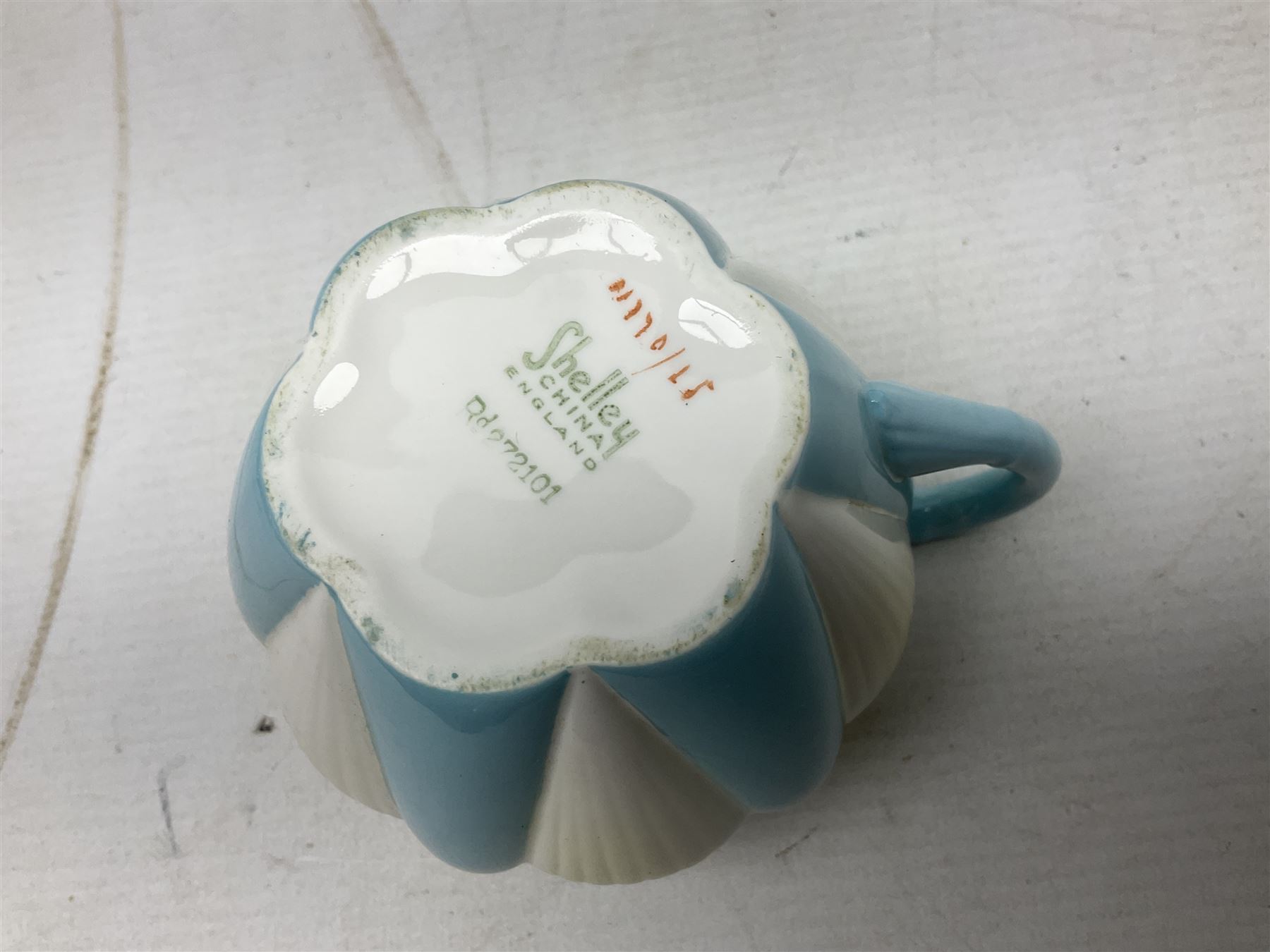 Shelley Dainty pattern tea wares, of lobed form with blue star decoration on merging white and yellow ground, comprising five teacups, five saucers, six tea plates, milk jug and cake plate, all with printed green mark beneath, some with painted pattern no 11770