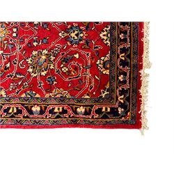 Central Persian Kashan crimson ground runner rug, the field decorated with interlacing branch and stylised flower head motifs, the guarded indigo border with repeating trailing foliate patterns