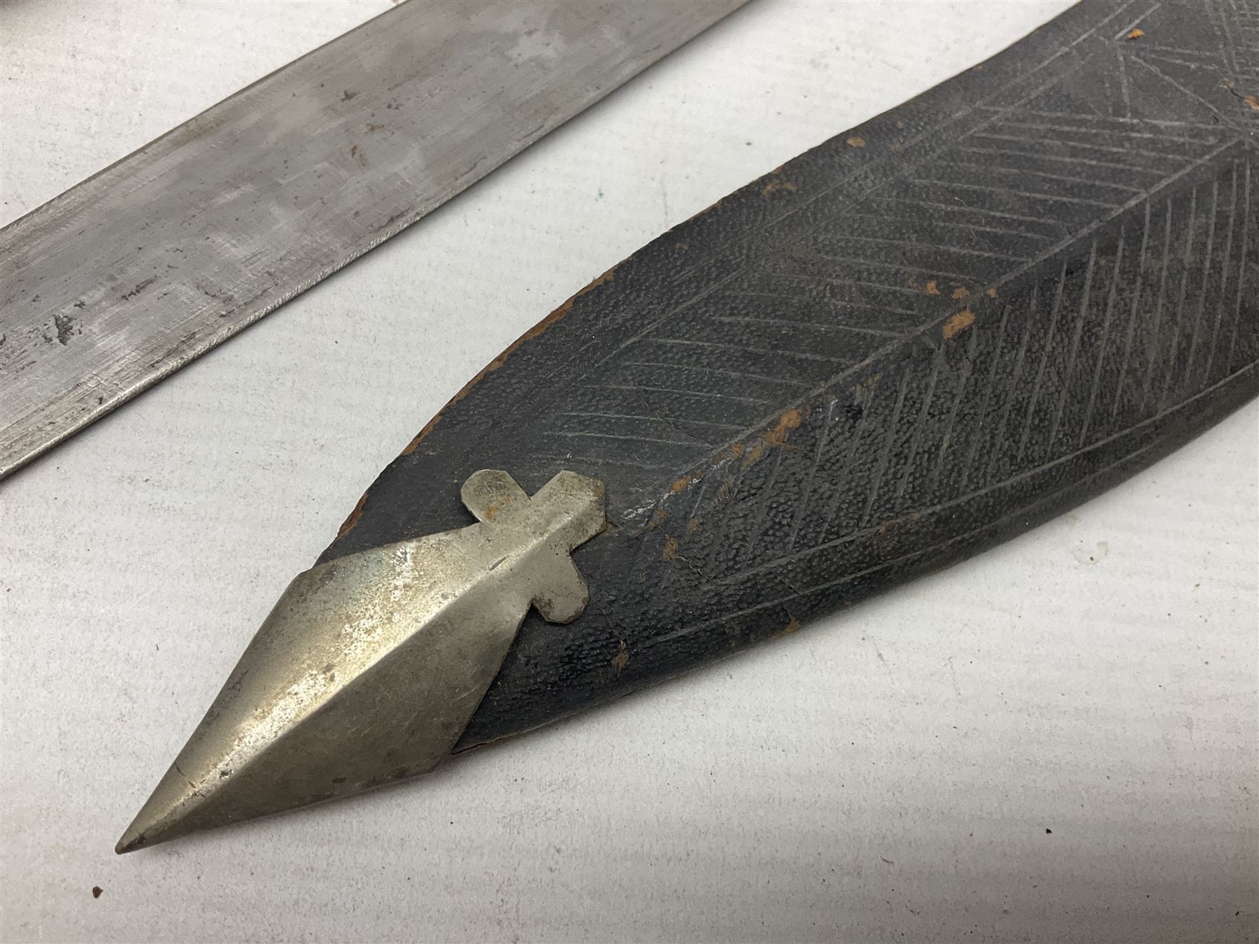 Indian kukri with 29cm curving steel blade and nickel mounted horn grip; in leather covered scabbard with one skinning knife L42cm overall; Hitler Youth knife with scabbard in relic condition; and three African graduated knives each with crudely carved wooden grips and painted leather covered scabbards (5)