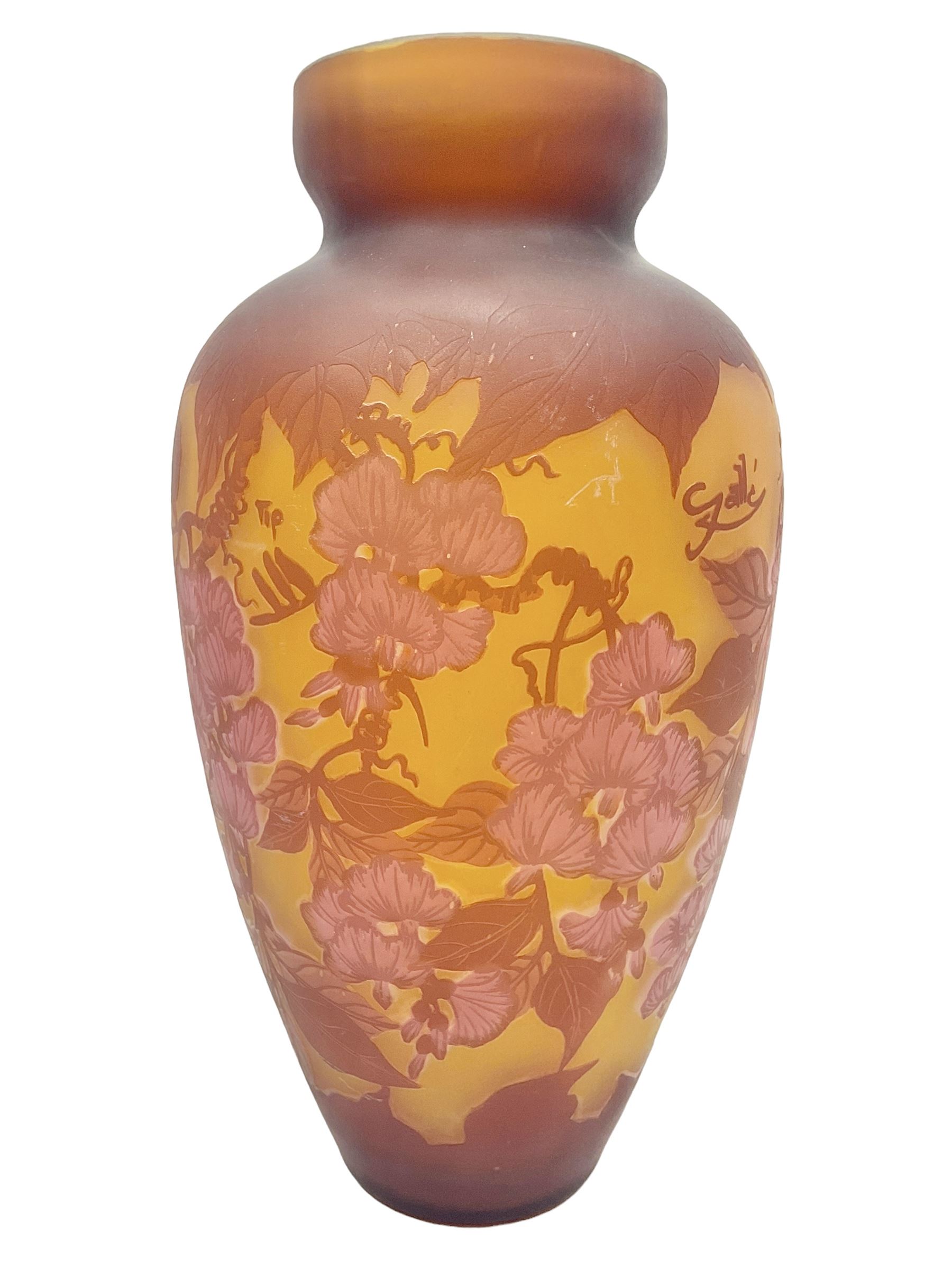 Art Nouveau style glass vase, in the style of Galle, the tapering body decorated with trailing red and pink foliage on a yellow ground, H33cm