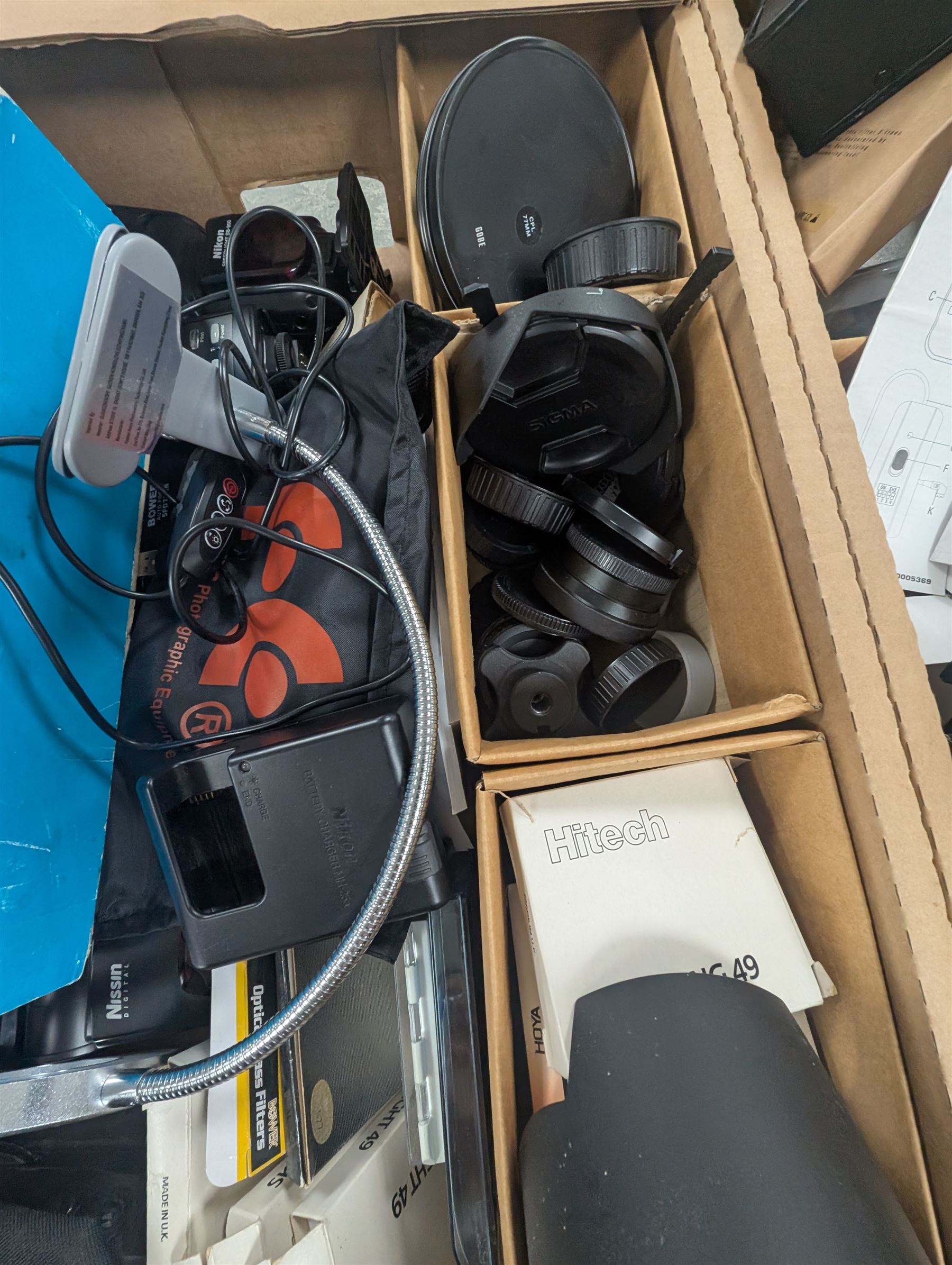 Collection of photography equipment, including flashes, hoods, filters, telephoto lens, bags, etc