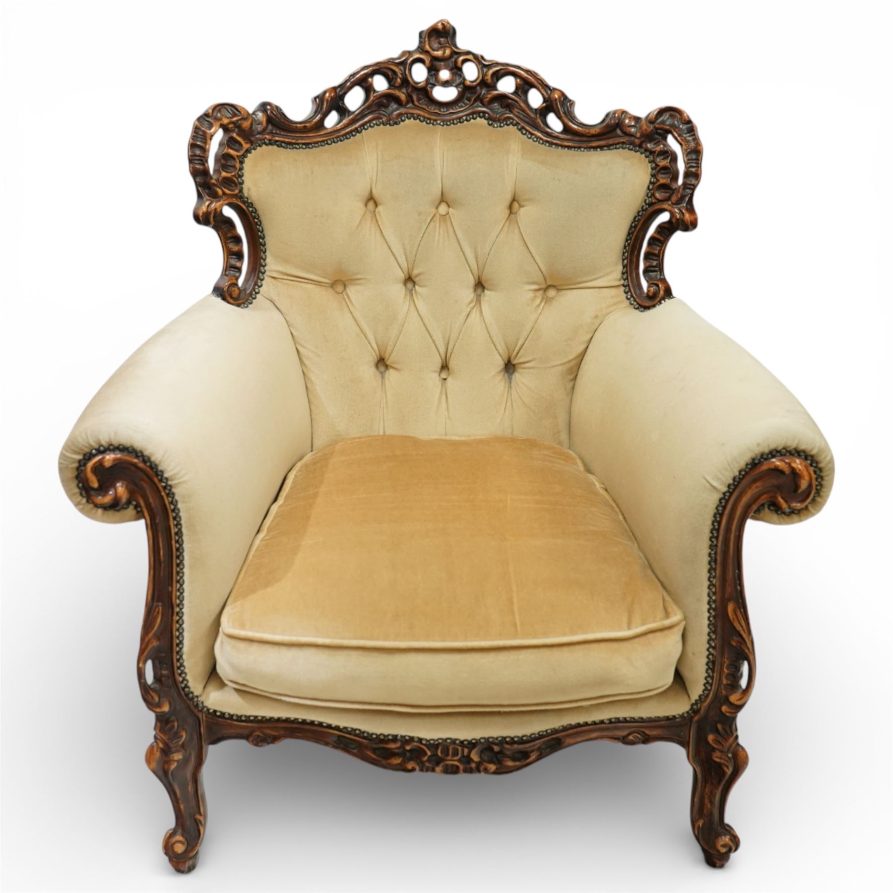 Late 19th century style carved hardwood armchair, the openwork crest rail with scrolling and foliate ornament, upholstered back and outscrolled arms with buttoning, loose seat cushion, nailhead trim, on carved cabriole legs