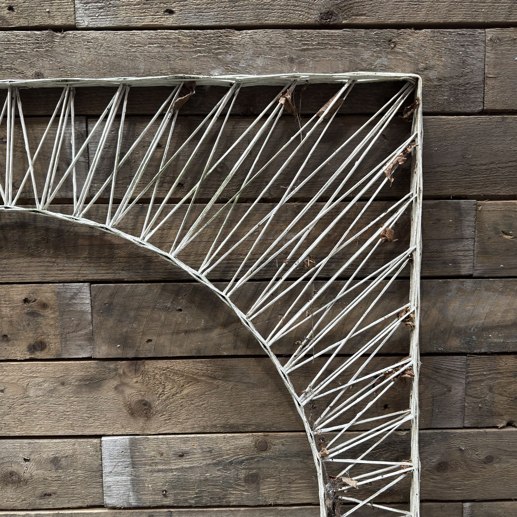 Four early 20th century French painted wicker garden trellis or dividers, rectangular form with internal arches