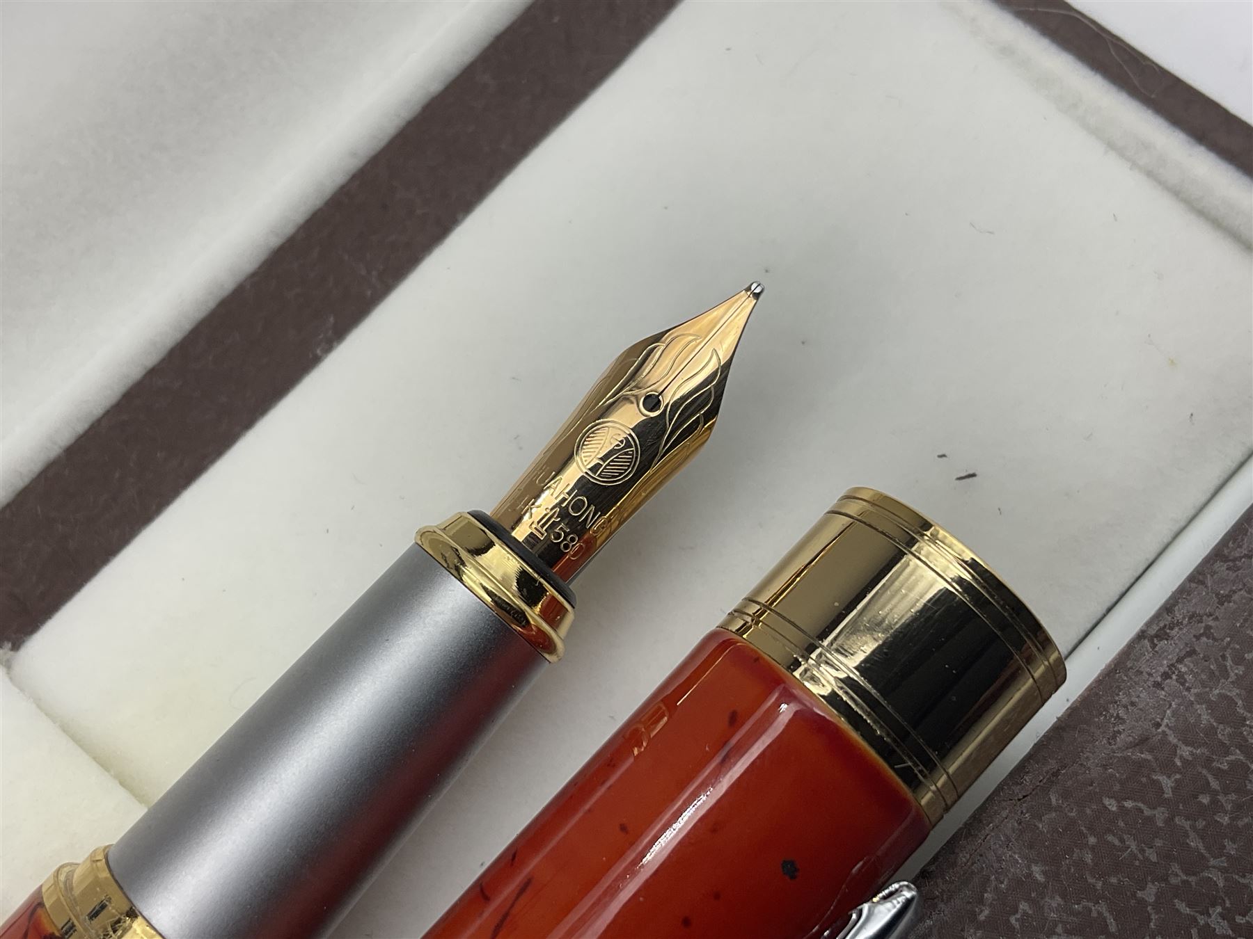 Circa 1930s Mentmore Auto Flow button fill fountain pen, the black barrel and cap with single narrow band and gold nib stamped Osmi Ridium 14ct, together with two gold nib fountain pens, each marked Huahong, the first stamped 14K 580, and second stamped 8K, both housed in Mentmore boxes (3)