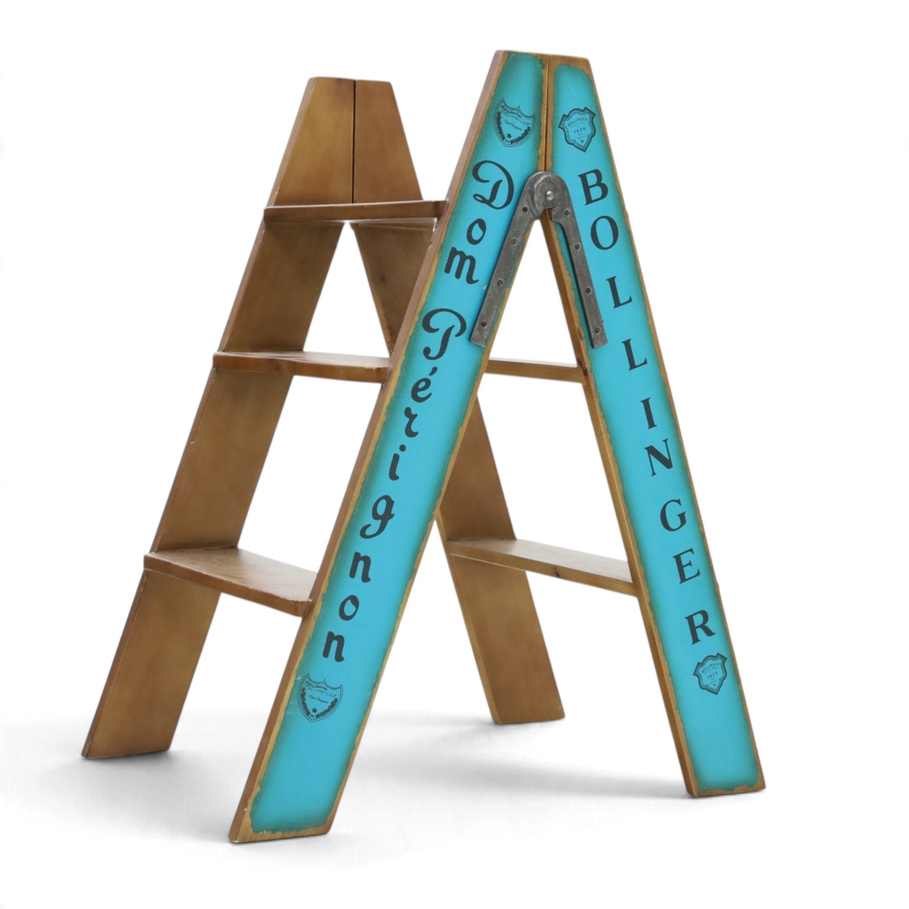 Contemporary wooden folding stepladder, three treads to each side, turquoise painted panels bearing champagne logos, with metal hinges and folding stays