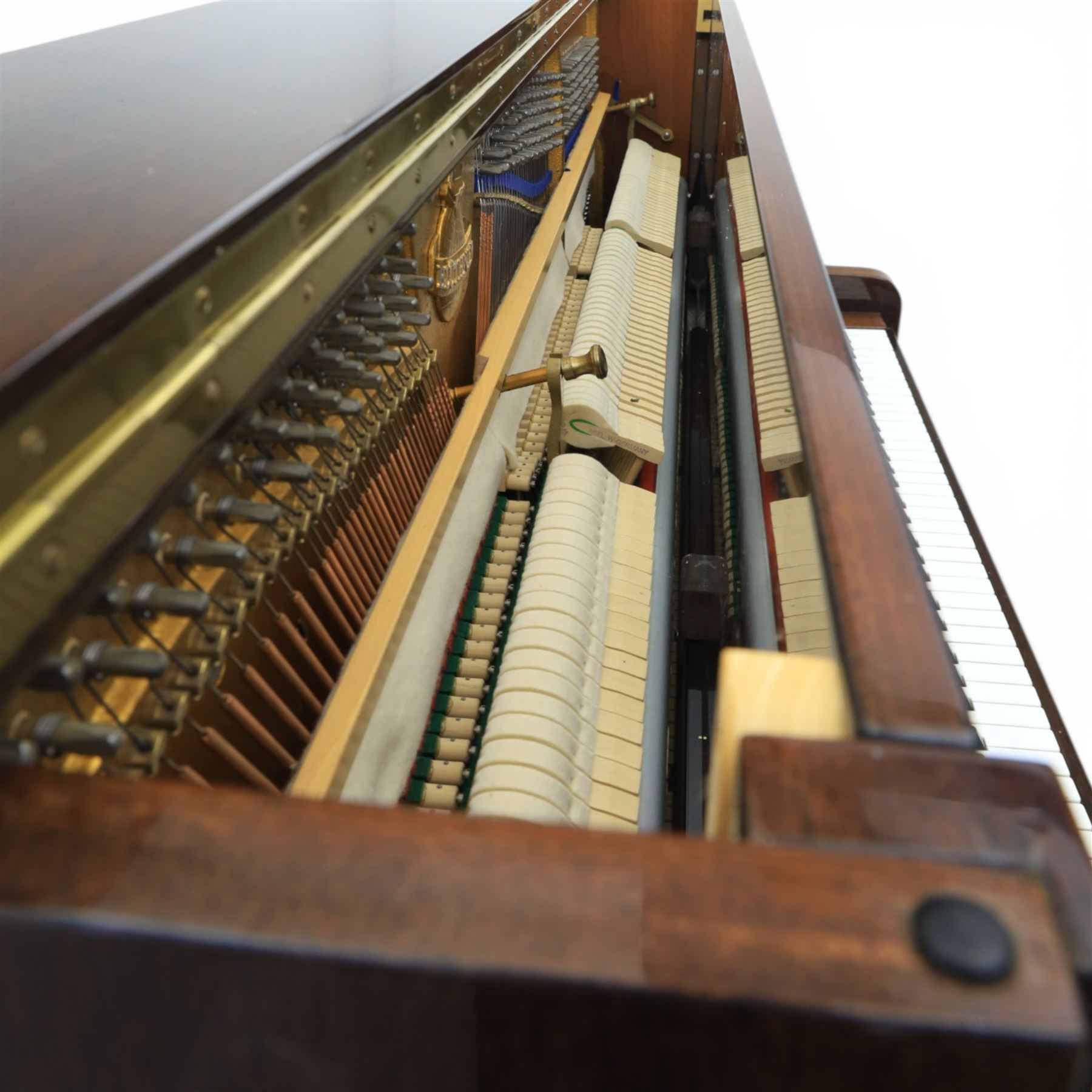 Bluthner of Leipzig upright piano, mahogany case with 88 keys and three brass pedals