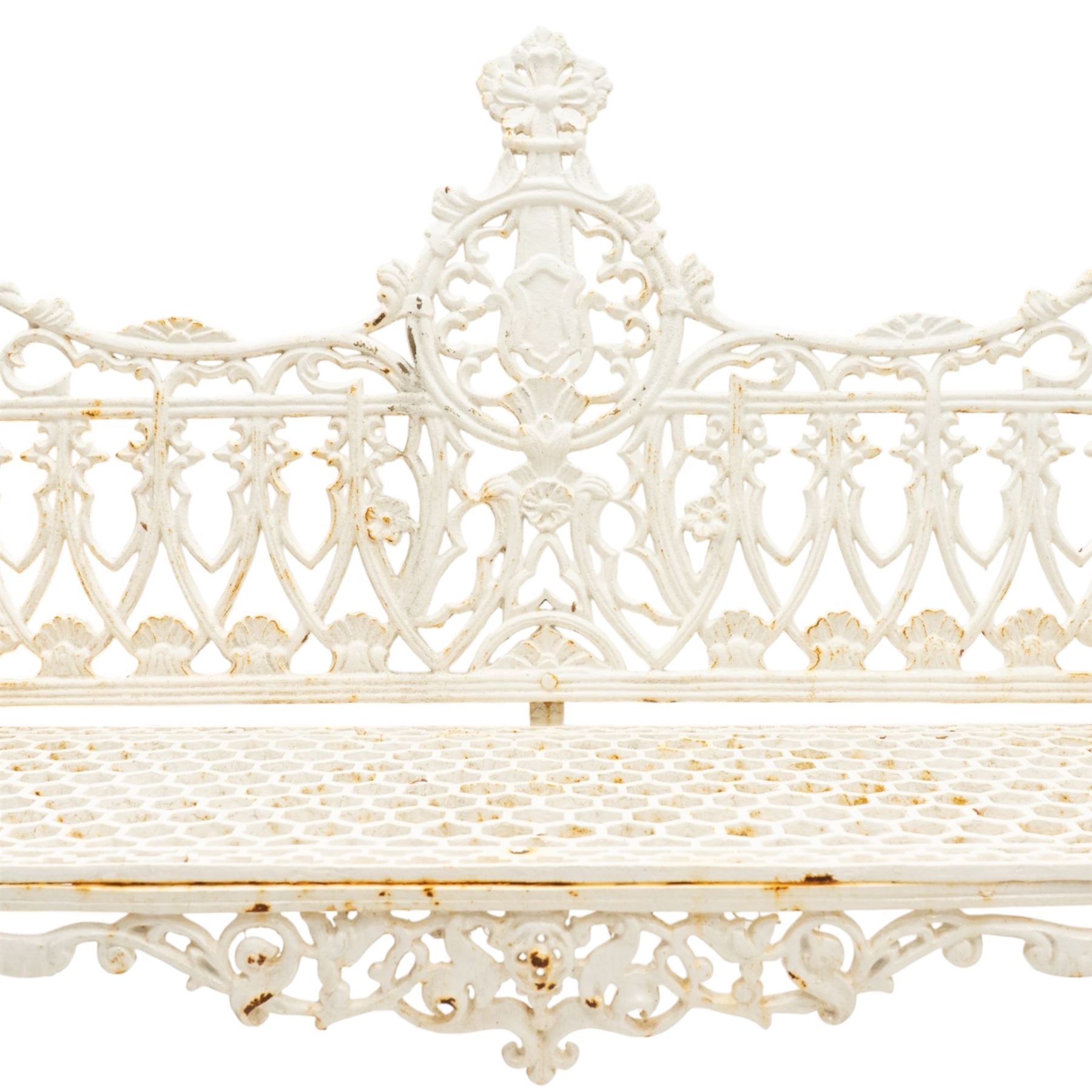Victorian revival heavy cast iron garden bench, ornate back rest with scrolls, floral motifs and central crest, pierced lattice seat, curved arms and decorative legs, painted in antique white, in the Gothic Coalbrookdale style