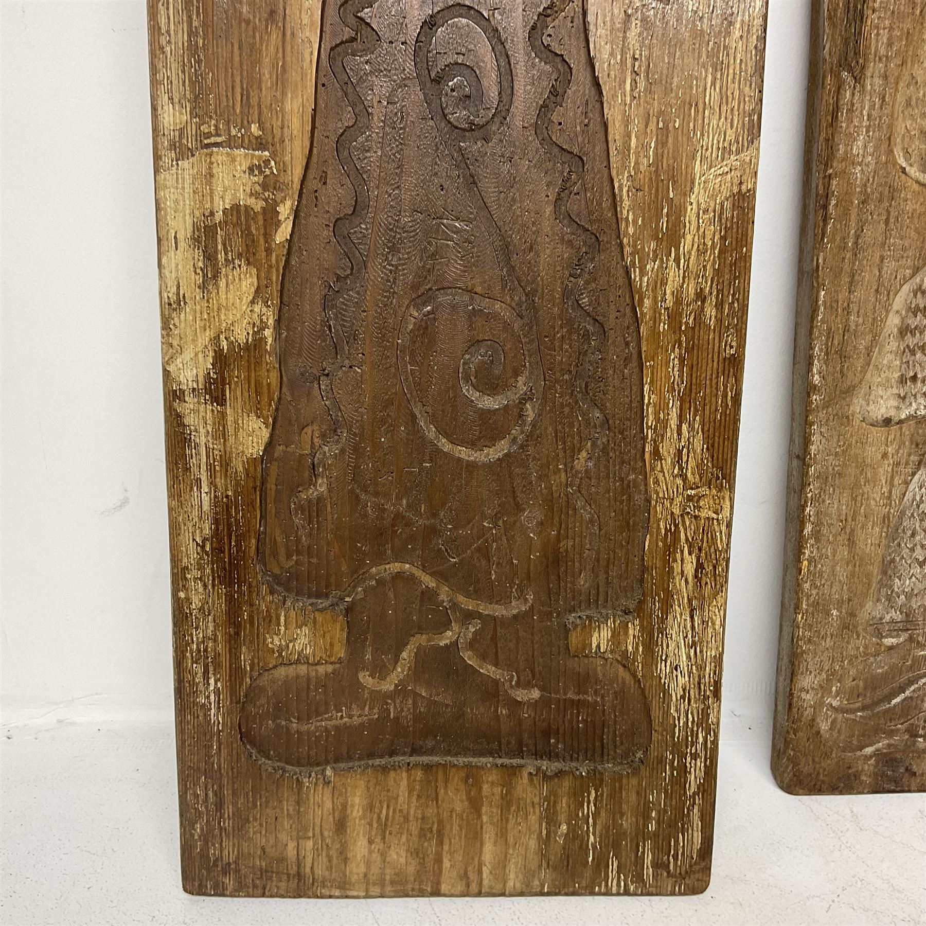 Two 20th century hardwood Dutch folk art Speculaasplank or biscuit moulds, typically carved with figures in traditional dress, largest H101cm