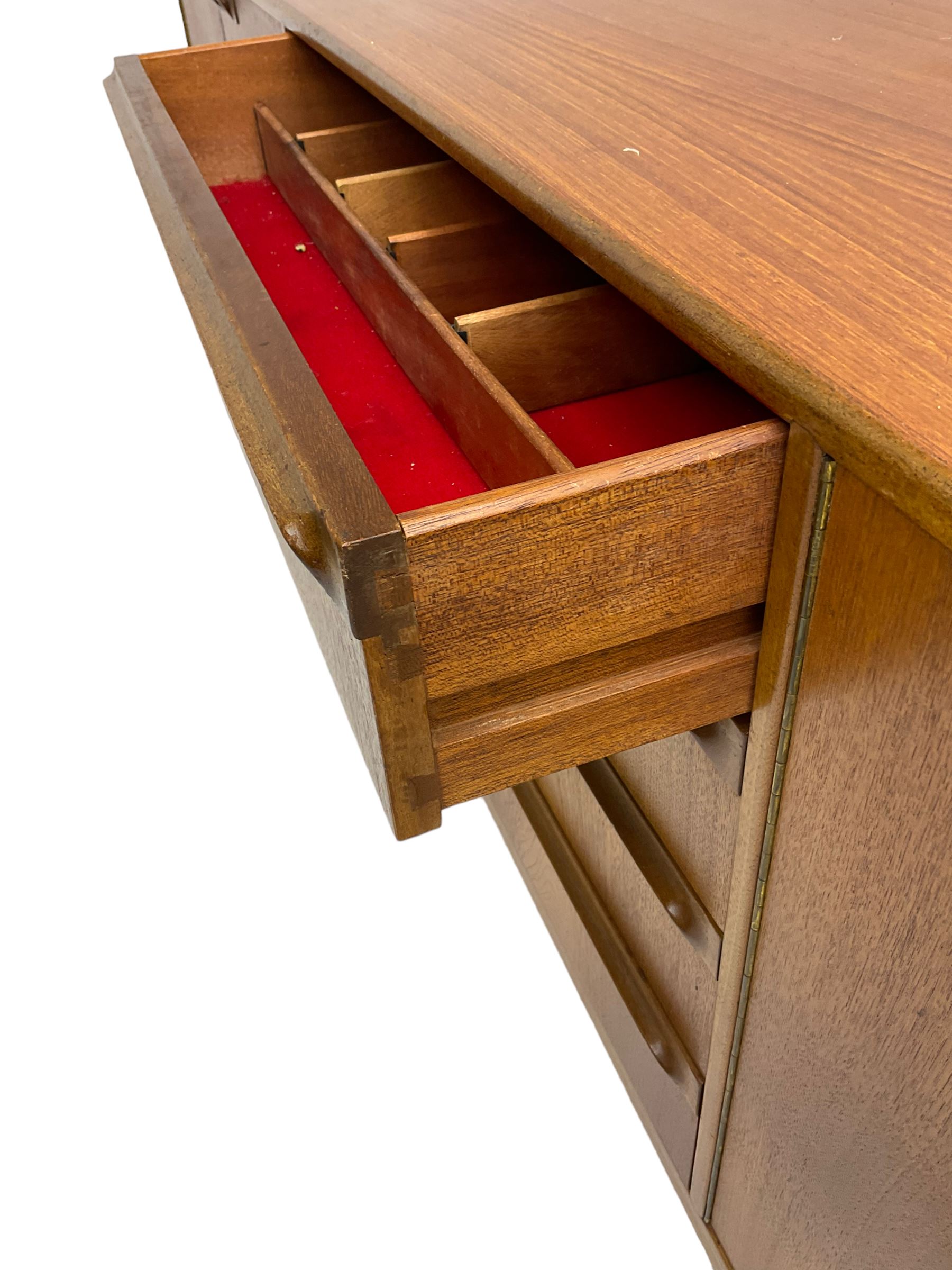Tom Robertson for AH McIntosh & Co of Kirkaldy - mid-20th century teak sideboard, fitted with four central drawers, flanked by cupboard enclosing shelves and sliding tray, raised on cylindrical supports