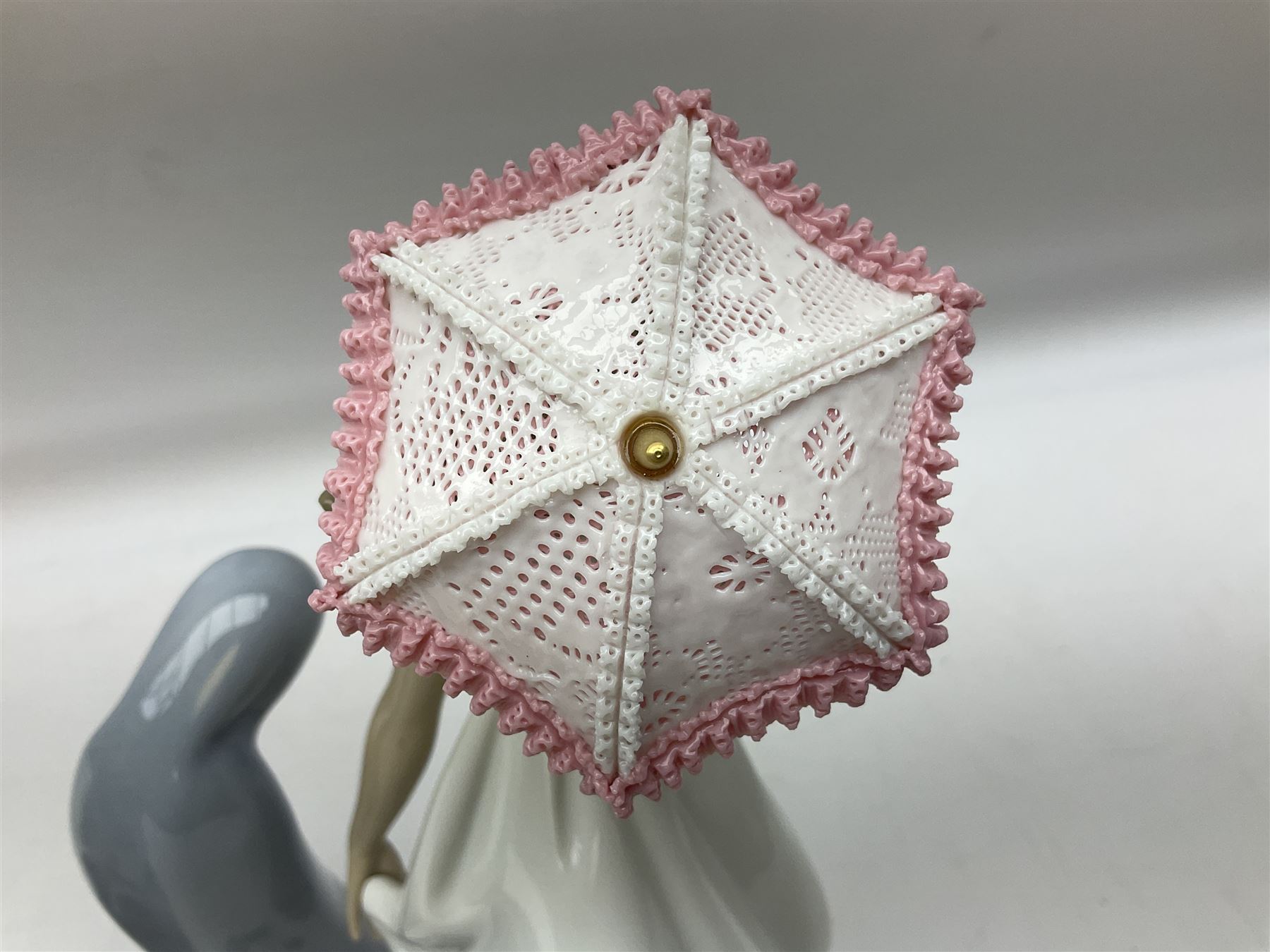 Four Lladro figures, comprising Afternoon Promenade no 7636, Nostalgia no 5071, both with original boxes, Girl with Lilies no 4972 and Madonna no 4534, largest example H27cm