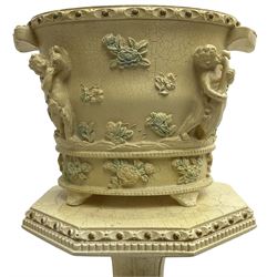 Baroque design ivory finish jardinière with stand, decorated with raised floral sprays and putto, on octagonal bulbous base with paw feet