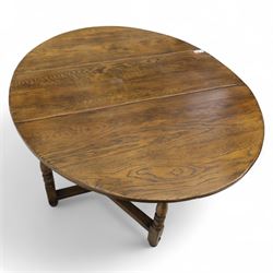 17th century design oak gateleg dining table, oval drop-leaf top on baluster turned supports, twin swinging gate legs united by peripheral stretchers (Extends to 149cm)